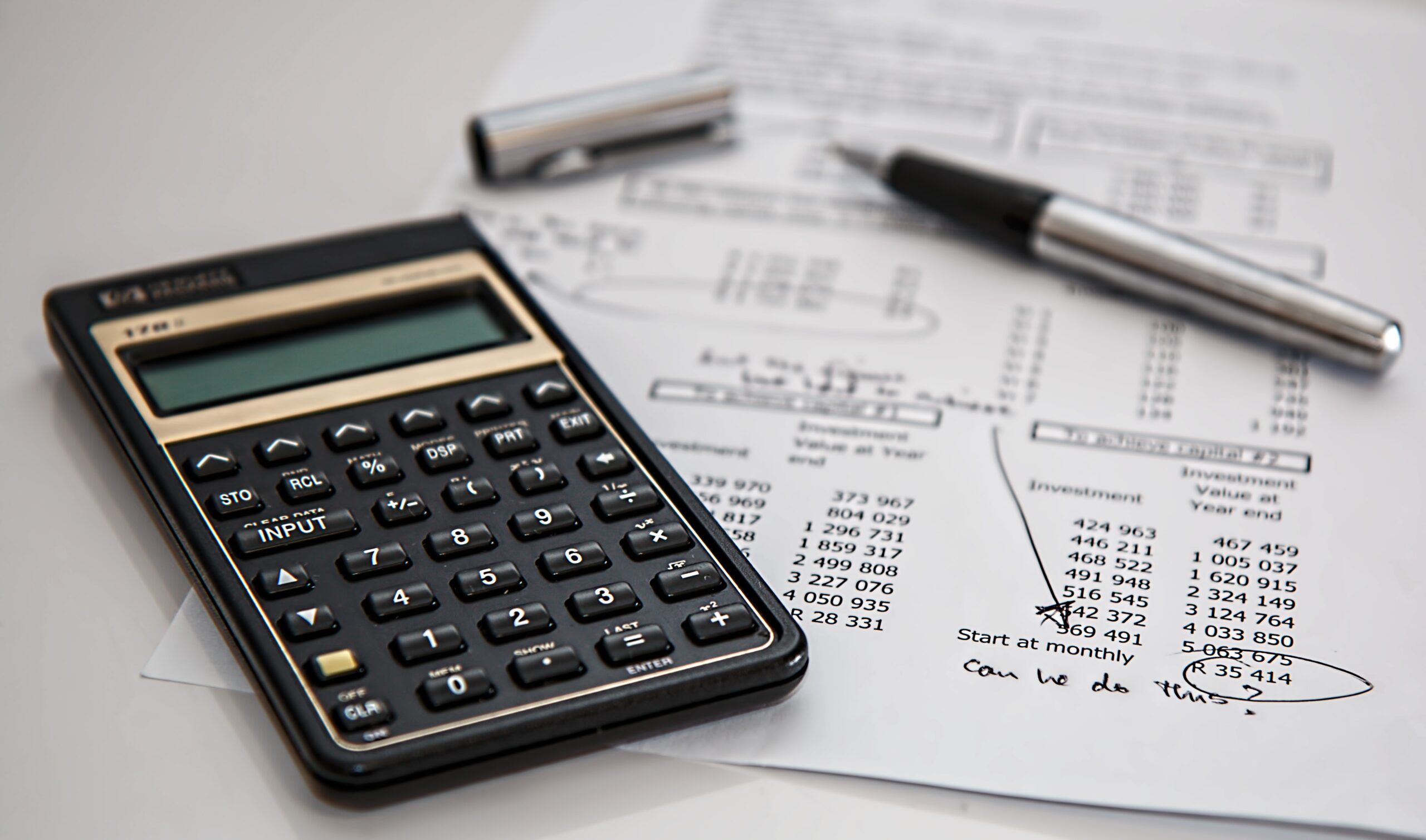 Pen, calculator to show finance calculations